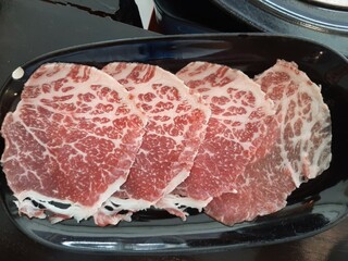 Thin Sliced Raw Beef on Black Plate
