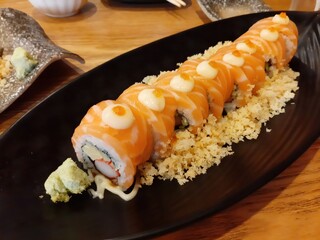 Salmon Sushi Roll on a Black Plate