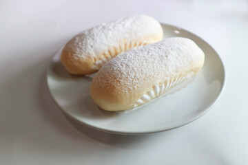 bun, bread or butter bread wih icing sugar