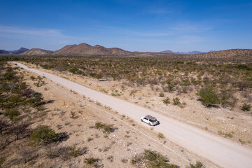 Car on the road in the middle of the Namib desert, Namibia, Africa 7.05.2024