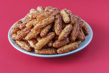 A large pile of sugar and cinnamon cookies on a plate