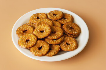 Round crackers with a hole and salt on a burlywood background