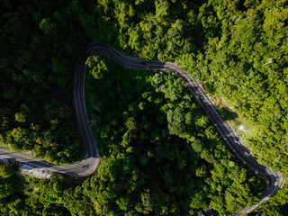 Aerial view apshalt curve road on mountain tropical rainforest