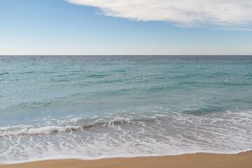 Empty sand beach on Mediterranean sea with horizon line vacation background