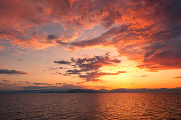 Beautiful golden sunrise over the rugged coastline of the island of Corsica lighting up the Mediterranean sea