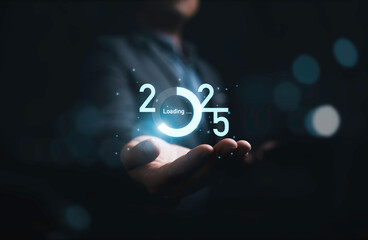 Businessman holding 2025 with loading progress for countdown of merry Christmas and happy new year...