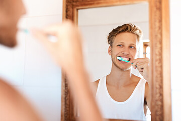 Dental care, smile and man brushing teeth by mirror in home for health, wellness and morning...