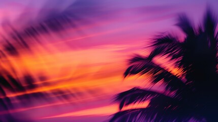 Blurred tropical sunset with palm trees in motion, giving an unique and dreamy look to the image.