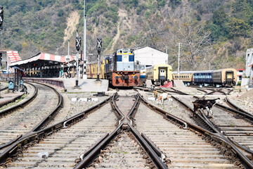Obraz premium View of train Railway Tracks from the middle during daytime at Kathgodam railway station in India, Train railway track view, Indian Railway junction, Heavy industry