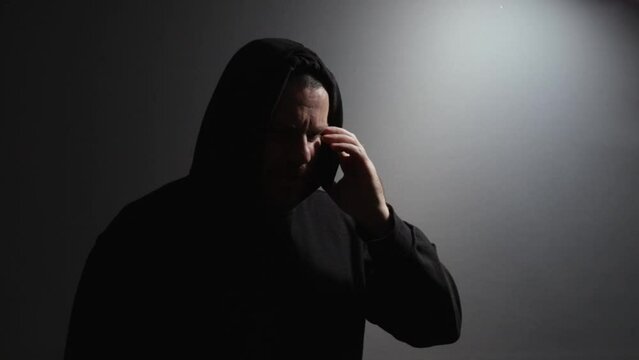 Stalker, a man talking on the phone, thief planning theft, protection of privacy.