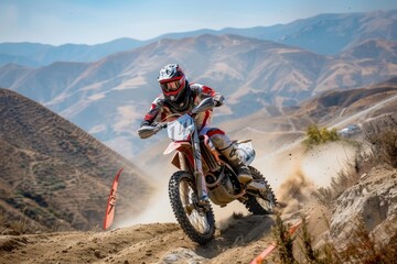A motocross race in a rugged terrain with mountains in the background