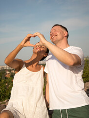 Close-up of couple making heart shape with hands