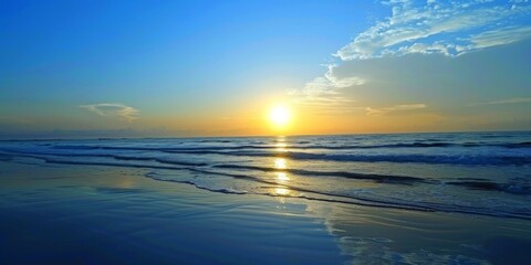 Fototapeta premium Sunset Over the Ocean at a Coastal Beach