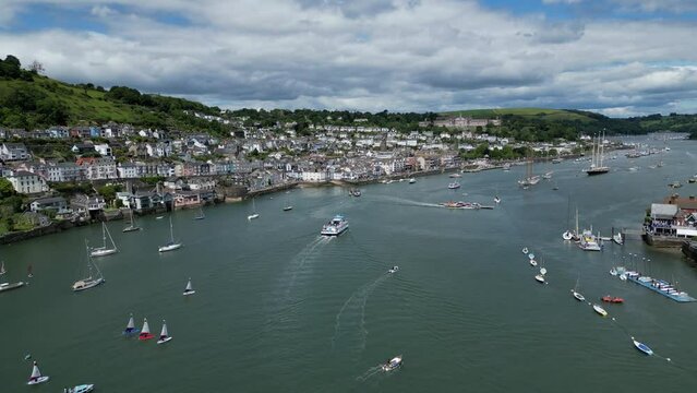 Dartmouth, South Devon, England: DRONE VIEWS: A tourist boat heads upriver towards Dartmouth quay as the Lower Ferry crosses towards Kingswear. Dartmouth is a popular UK holiday destination (1).