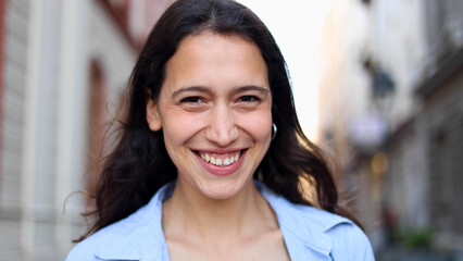 Fototapeta premium Portrait of a happy young woman with a beautiful smile