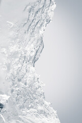 Pure transparent textured crushed ice piece on a white background.