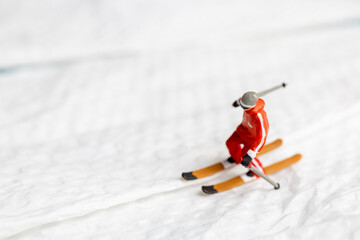 A miniature figurine of a skier dressed in vibrant winter gear. This image is perfect for themes...