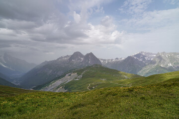 Fototapeta premium Beautiful views over the mountains with snow on the top of the mountains. The nature while hiking the Tour du Mont Blanc. 