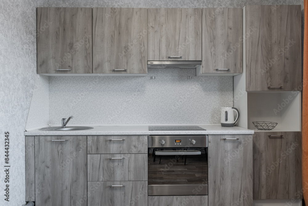 Wall mural grey kitchen. kitchen with appliances, microwave, oven. white countertop in the kitchen. metal sink