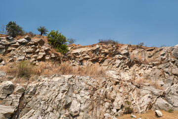 rough textured walls of rocky cliff surrounding Marble Lake in Baghmundi, Purulia. Extension of Ajodhya Hill and part of Chhotanagpur Plateau, the place has become a popular destination for ecotourism