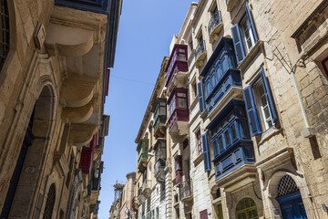 Fototapeta premium Tipical street of La Valletta with wooden terraces in Malta.