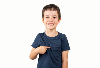 This is me. Portrait of happy preschool boy in blue shirt joyfully looking at camera and pointing...