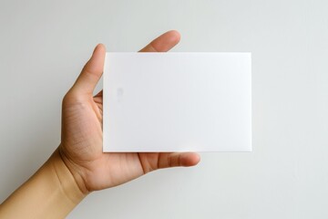 Obraz premium Blank White Card Mockup on Hand created with Generative AI