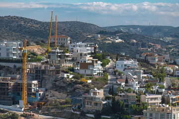 Urban expansion: construction crane over residential area in Limassol, Cyprus