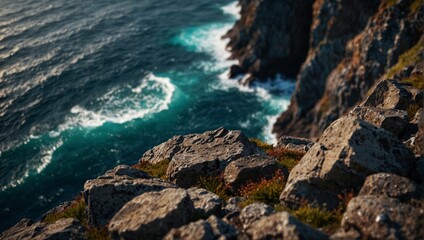 Bird s eye perspective of a chasm precipice and boulders overlooking a crystalline ocean below.