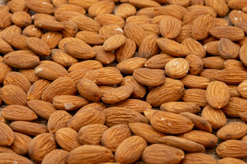 Close-up roasted and peeled almonds on a piece of burlap