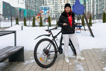 Woman riding a bicycle in frosty weather
