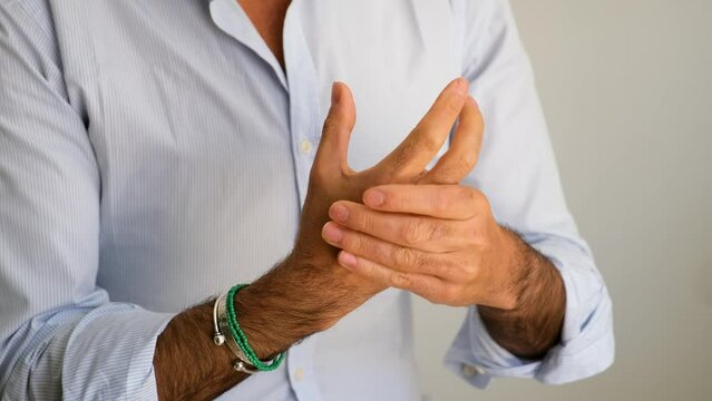 Close up of a mature man hands cracking the knuckles