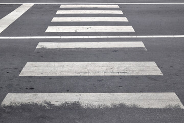 perspective grunge zebra crossing, damaged white painted zebra crosswalk with dirty stain on tarmac road