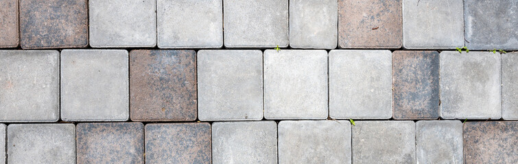 Grey and brown cobblestone pavement forming a textured background