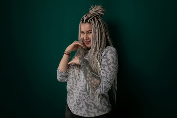 Woman With Dreadlocks in Front of Green Wall
