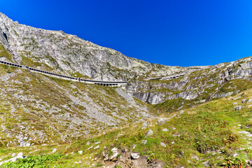 Scenic view of mountain pass road named Tremola at Swiss mountain pass Gotthard on a sunny late summer day. Photo taken September 10th, 2023, Gotthard, Canton Ticino, Switzerland.