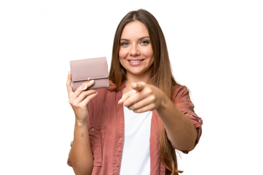 Young blonde woman holding a wallet over isolated chroma key background points finger at you with a confident expression