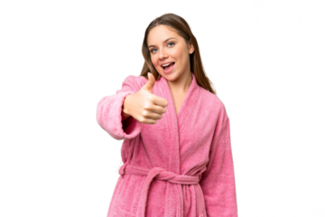 Young woman in a bathrobe over isolated chroma key background with thumbs up because something good has happened