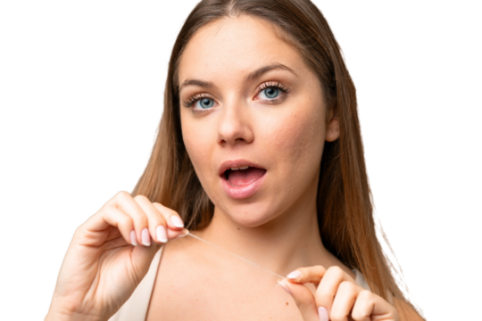 Young blonde woman over isolated chroma key background with dental floss. Close up portrait