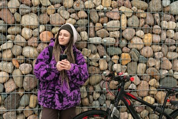 Bicycle rental concept. A young woman with dreadlocks spent a walk around the city riding a bicycle