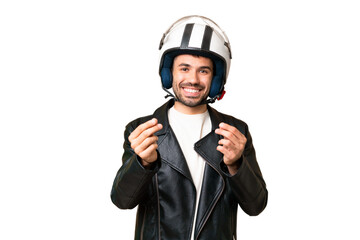 Young caucasian man with a motorcycle helmet over isolated chroma key background making money gesture
