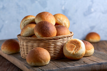 Basket with freshly baked golden crust buns.