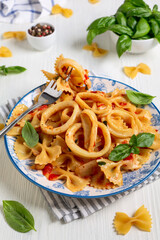 Homemade pasta with calamari and tomato sauce.