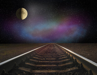 View of rails and the moon at night. Night railway road. Travel concept