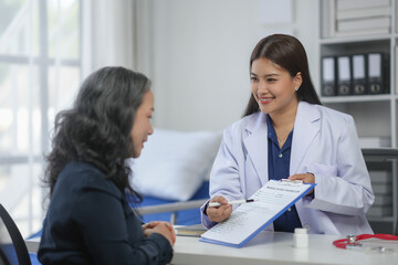 A doctor discussing a patient's health report during a consultation in a modern clinic.