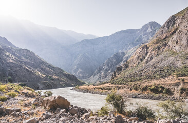 The Panj River flows in a mountain valley of the Pamir Mountains in Tajikistan, the border between Tajikistan and Afghanistan