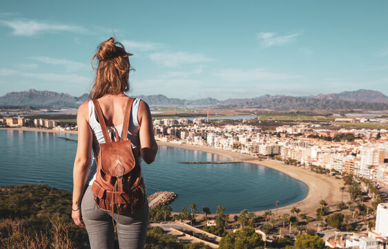 Female enjoying panoramic view of mediterranean sea and city landscape in Spain