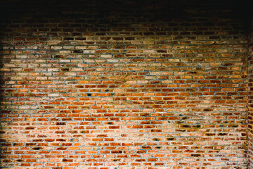 Naklejka premium A brick wall with a few bricks missing. The wall is brown and has a rough texture