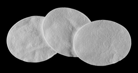 Group absorbent cotton wool pads, swabs, ellipse wadding isolated on black, top view	