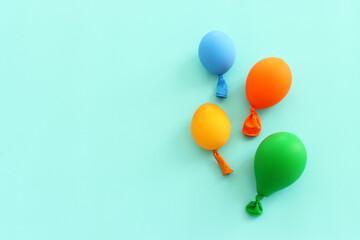 Top view image of colorful ballons on blue pastel background
